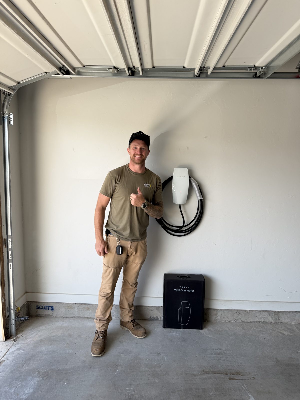 Dustin Jones of Jones Electric Co. with a completed EV charger installation